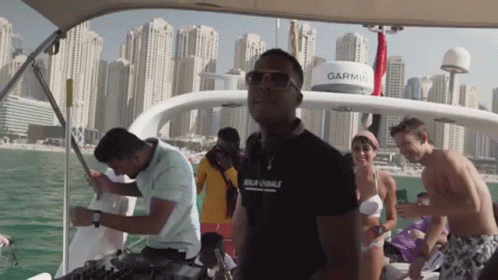 A Group Of People On A Boat With A Garmin On The Top GIF