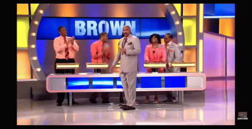 A Group Of People On A Game Show With The Name Brown On The Screen GIF