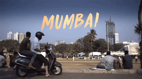 A Group Of People On Scooters In Front Of A Sign That Says ' Mumbai ' On It GIF