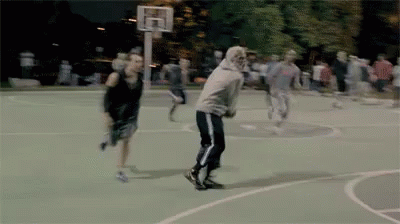 a group of people playing basketball on a court