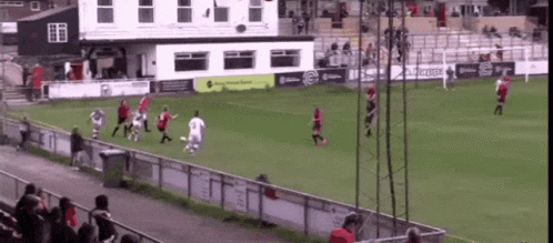 A Group Of People Playing Soccer On A Field With A Building In The Background That Says ' Kappa ' GIF