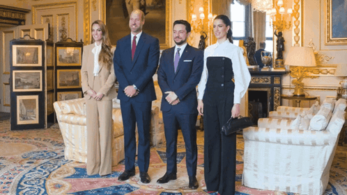 A Group Of People Posing For A Photo In A Room GIF
