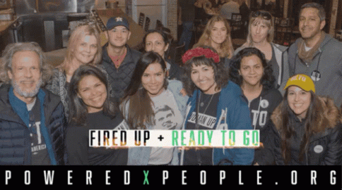 A Group Of People Posing For A Photo With The Words Fired Up + Ready To Go Behind Them GIF