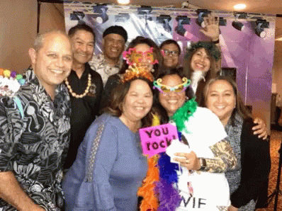 A Group Of People Posing For A Picture With One Woman Holding A Sign That Says " You Rock " GIF