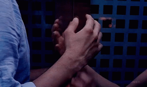 A Group Of People Putting Their Hands Together In A Circle GIF