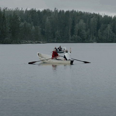 A Group Of People Rowing A Boat In A Lake With La Guarimba Film Festival Written On The Bottom Of The Image GIF