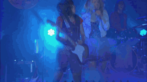 A Group Of People Singing In Front Of A Sign That Says " Determine " GIF