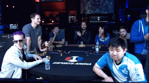 A Group Of People Sitting Around A Table That Says Esports Arena On It GIF