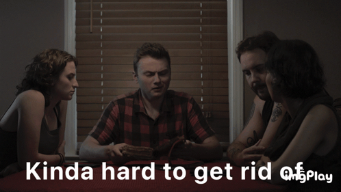 A Group Of People Sitting Around A Table With Something You Can 'T See Play Written In White Letters GIF