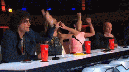 A Group Of People Sitting At A Table With Coca Cola Cups On It GIF