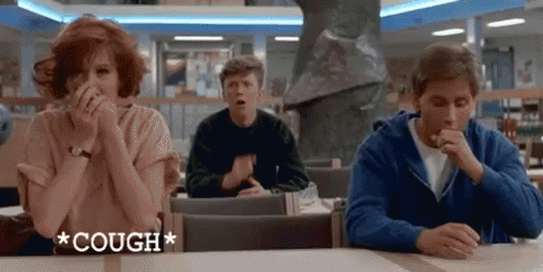 A Group Of People Sitting At A Table With The Word Cough Written On It GIF