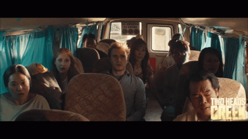 A Group Of People Sitting In A Bus With The Words Two Heads Chicken Written On The Bottom GIF