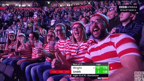 A Group Of People Sitting In A Stadium Watching A Game With A Scoreboard That Says Best Of 12 Wright Smith GIF