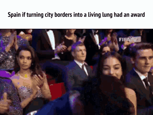 A Group Of People Sitting In A Stadium With The Caption Spain If Turning City Borders Into A Living Lung Had An Award . GIF