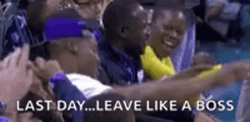 a group of people sitting in a stadium with the words `` last day ... leave like a boss '' written on the bottom .