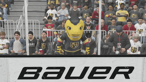A Group Of People Sitting In Front Of A Sign That Says Bauer On It GIF