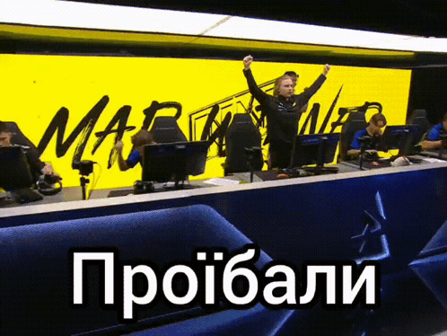 A Group Of People Sitting In Front Of A Yellow Sign That Says Mar GIF