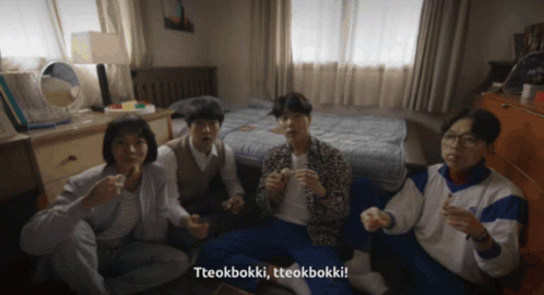 A Group Of People Sitting On The Floor With Tteokbokki Written On The Bottom Right GIF