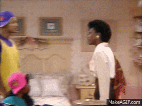 A Group Of People Standing Around A Bed With A Makeagif.com Watermark GIF