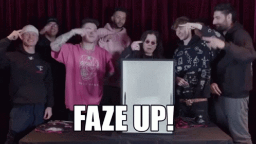 A Group Of People Standing Around A Table With A Sign That Says Faze Up In Front Of Them GIF