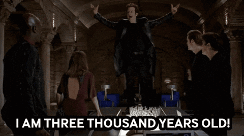 a group of people standing around a table with the words " i am three thousand years old " on it