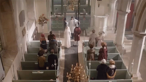 A Group Of People Standing In A Church With A Priest GIF