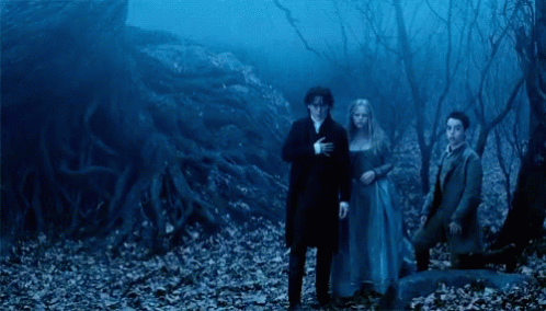 A Group Of People Standing In A Dark Forest With A Blue Sky In The Background GIF
