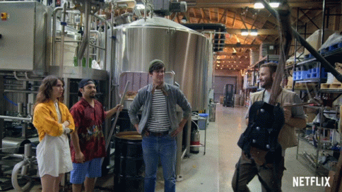 Group Standing In Factory With Netflix Logo GIF