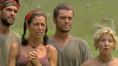 A Group Of People Standing In A Field With One Woman Wearing A Necklace That Says Cbs On It GIF