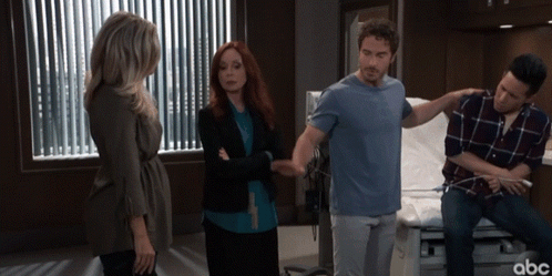 A Group Of People Standing In A Hospital Room With Abc Written On The Bottom Right GIF