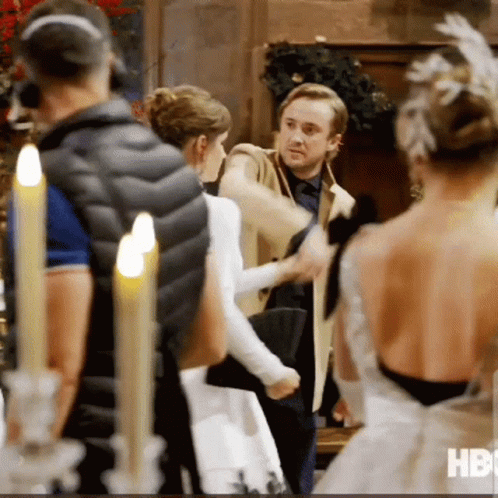 A Group Of People Standing In A Room With Candles And The Word Hbo On The Bottom Right GIF