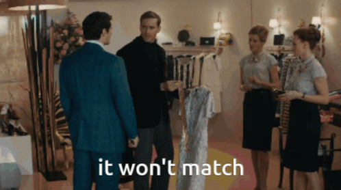 A Group Of People Standing In A Room With The Words " It Won 'T Match " GIF
