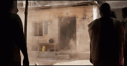 A Group Of People Standing In Front Of A Building With A Sign That Says ' No Smoking ' On It GIF