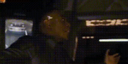 A Group Of People Standing In Front Of A Building With The Words `` But Ho '' Written On The Bottom Of The Image . GIF
