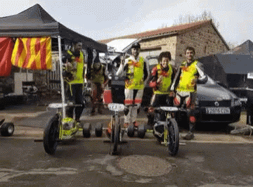 A Group Of People Standing In Front Of A Car With A License Plate That Says Yv7lc Gpd GIF