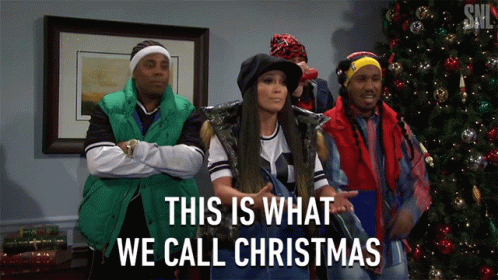 A Group Of People Standing In Front Of A Christmas Tree With The Words This Is What We Call Christmas GIF