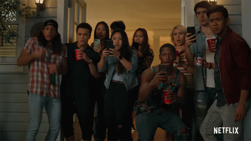 A Group Of People Standing In Front Of A House With Netflix Written On The Bottom Right GIF