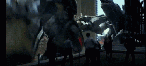 A Group Of People Standing In Front Of A Large Statue GIF