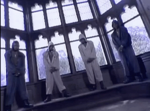 A Group Of People Standing In Front Of A Large Window GIF