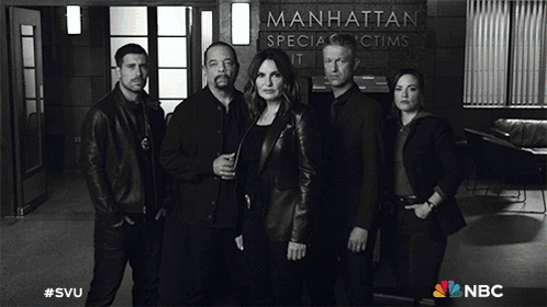 A Group Of People Standing In Front Of A Manhattan Special Victims Unit Sign GIF