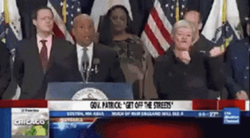 A Group Of People Standing In Front Of A Podium That Says " Gov. Patrick " On It GIF