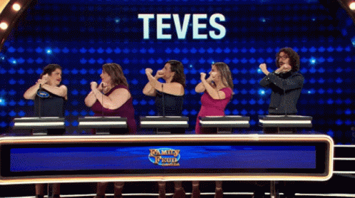 A Group Of People Standing In Front Of A Screen That Says Teves On It GIF
