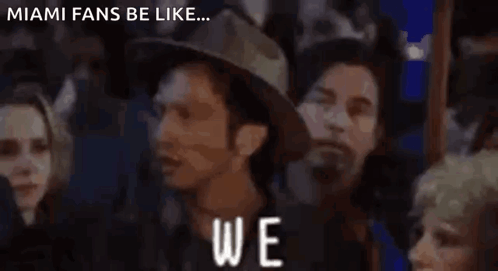 A Group Of People Standing In Front Of A Sign That Says " Again " GIF