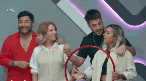 A Group Of People Standing In Front Of A Sign That Says " Rtve " GIF