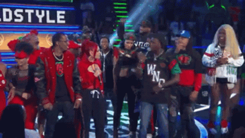 A Group Of People Standing In Front Of A Sign That Says Walkin ' Ahh ! GIF