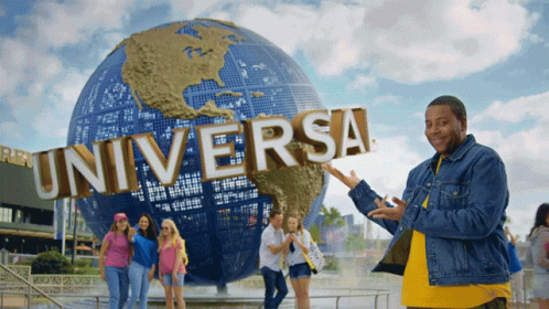 A Group Of People Standing In Front Of A Universal Sign GIF
