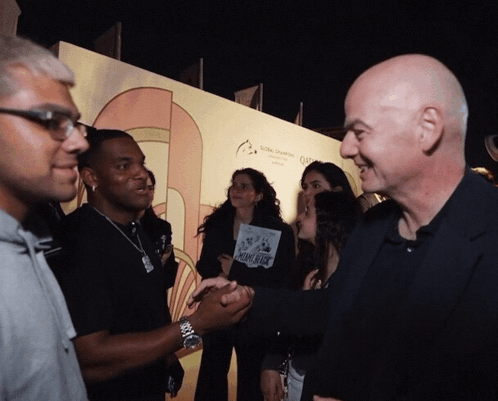 A Group Of People Standing In Front Of A Wall That Says Global Changing GIF