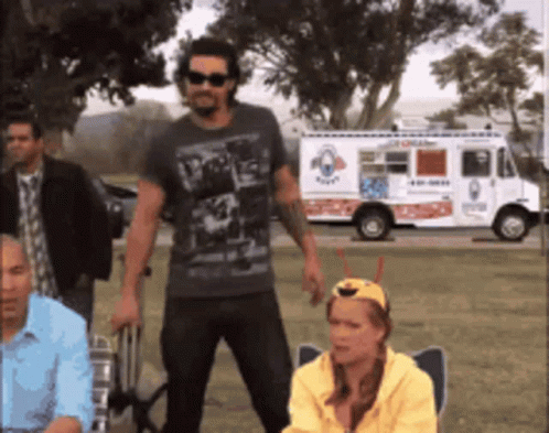 A Group Of People Standing In Front Of An Ice Cream Truck That Says Ice Cream GIF