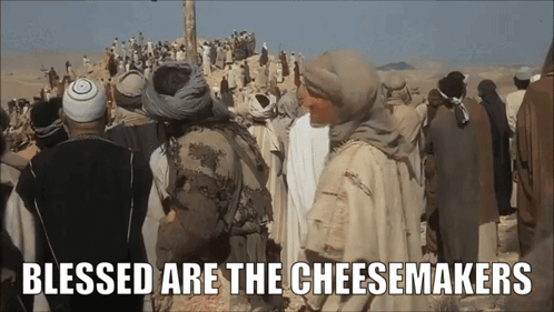 A Group Of People Standing In The Desert With The Words Blessed Are The Cheesemakers GIF