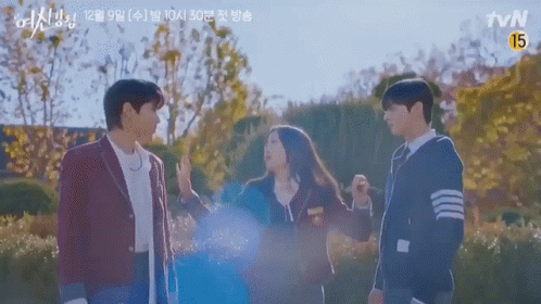 A Group Of People Standing Next To Each Other In A Park With Trees In The Background . GIF
